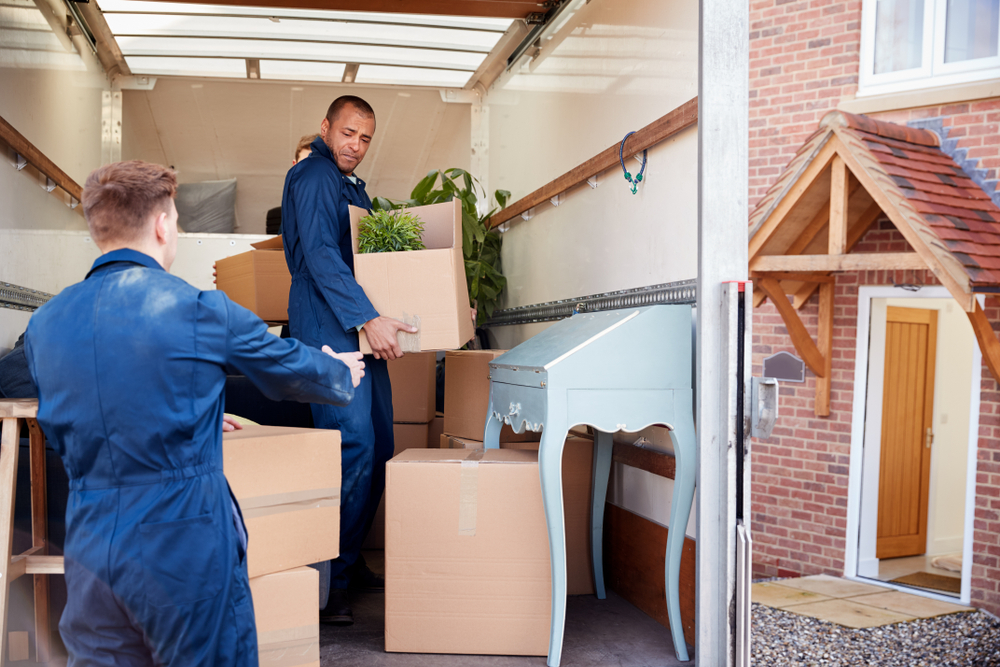 here's how to choose a good moving company. photo of movers in moving truck loading boxes