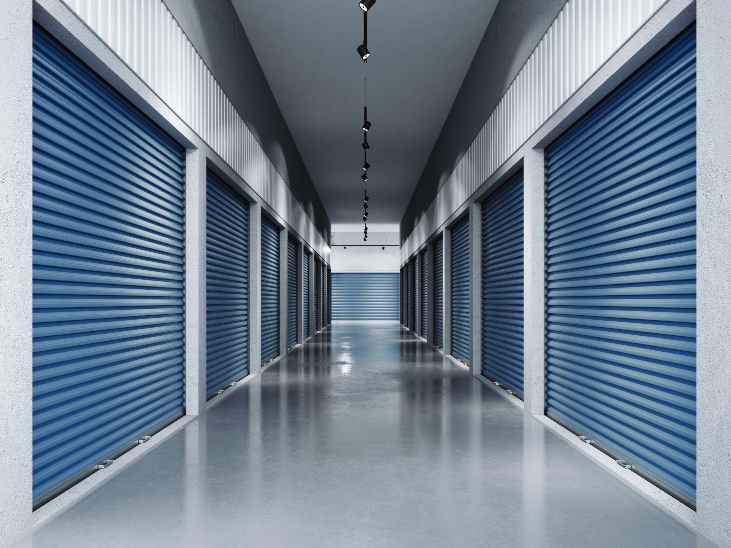self storage do's and don'ts - self storage well lit hallway with blue rolling doors