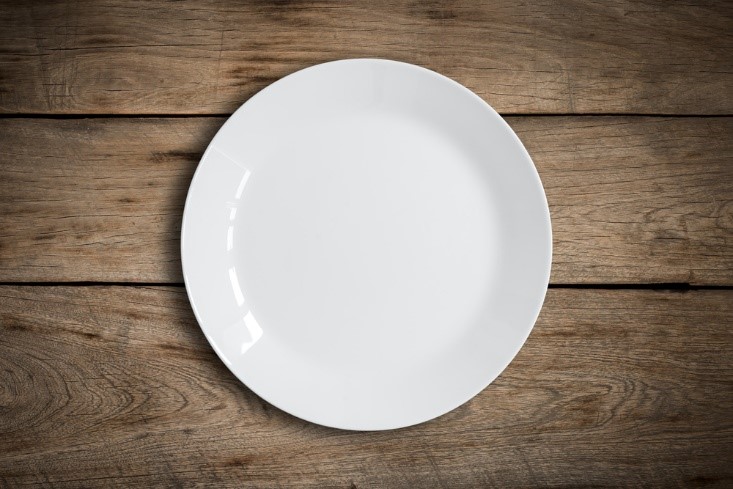 white plate on wood