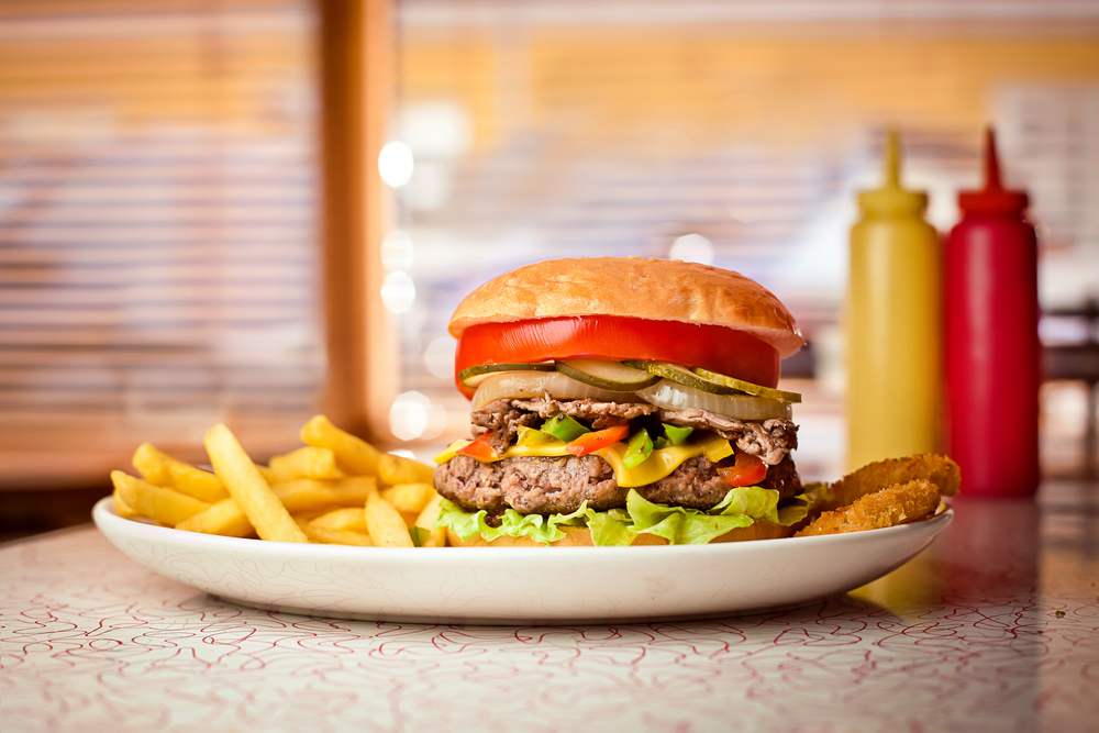 Close up of a hamburger and french fries on a plate